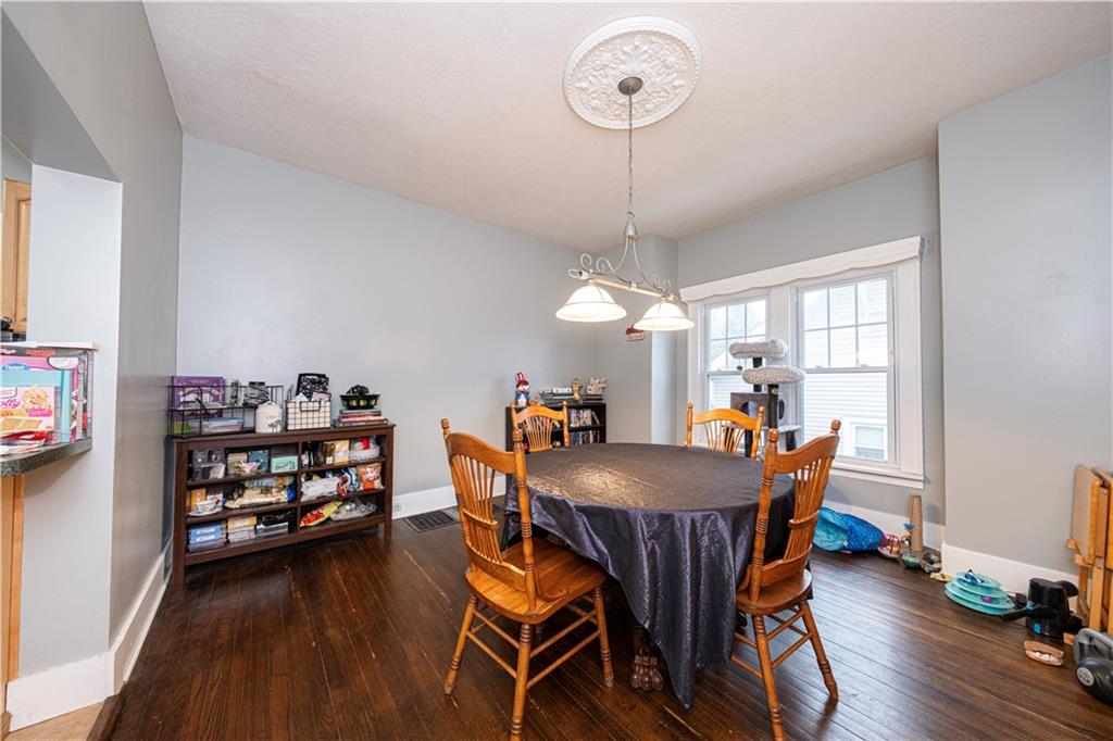 4263 Evergreen Road Pittsburgh, PA 15214 - Photo 5 of 28 a view of a dining room with furniture wooden floor and a chandelier
