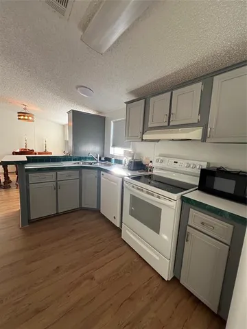a kitchen with stainless steel appliances granite countertop a sink and cabinets