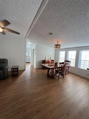 a view of a dining room with furniture and chandelier