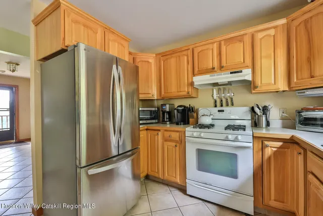 a kitchen with stainless steel appliances granite countertop a refrigerator sink and cabinets