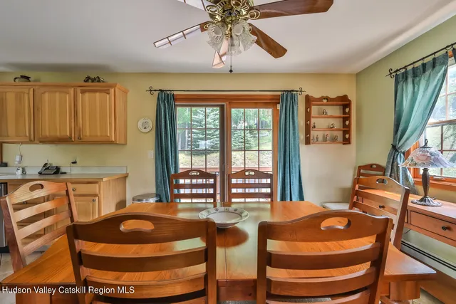 a table and chairs in a room with kitchen view