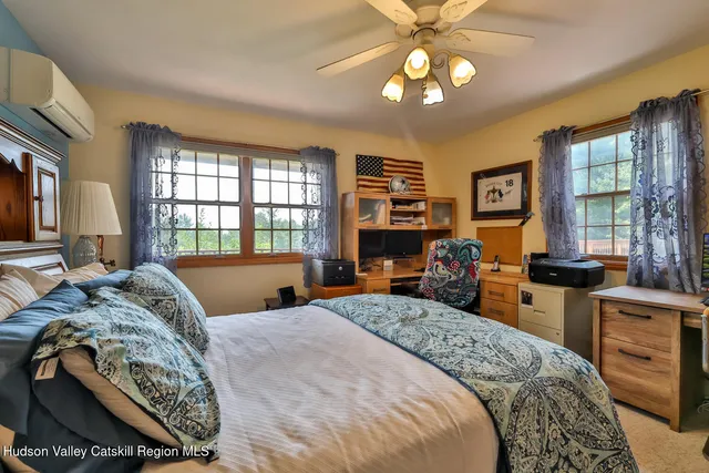 a bed room with a bed and a tv