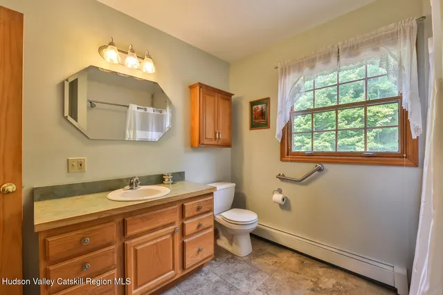 a bathroom with a toilet sink and mirror