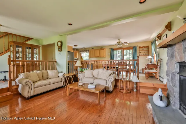 a living room with fireplace furniture and a wooden floor