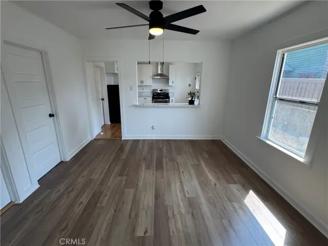a view of a kitchen with wooden floor a sink and a window