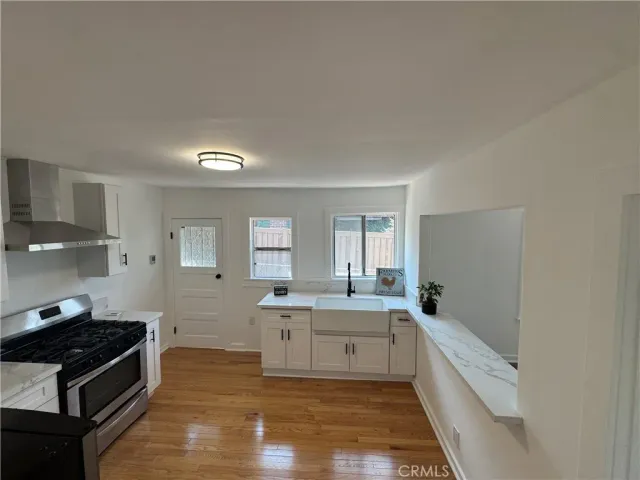 a kitchen with a sink stove and cabinets
