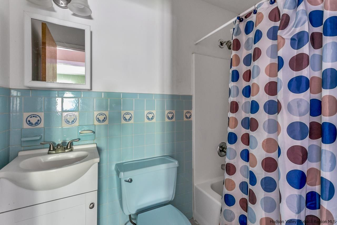 665 Scotchtown Collabar Road Middletown, NY 10941 - Photo 13 of 22 a bathroom with a sink toilet and mirror