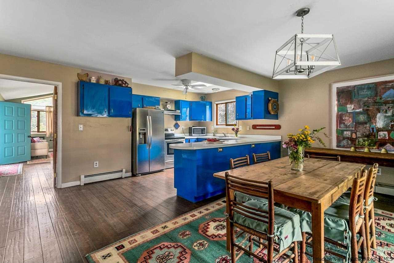 665 Scotchtown Collabar Road Middletown, NY 10941 - Photo 6 of 22 a kitchen with stainless steel appliances wooden floor dining table and chairs