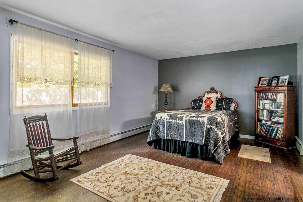 665 Scotchtown Collabar Road Middletown, NY 10941 - Photo 9 of 22 a bedroom with a bed and wooden floor