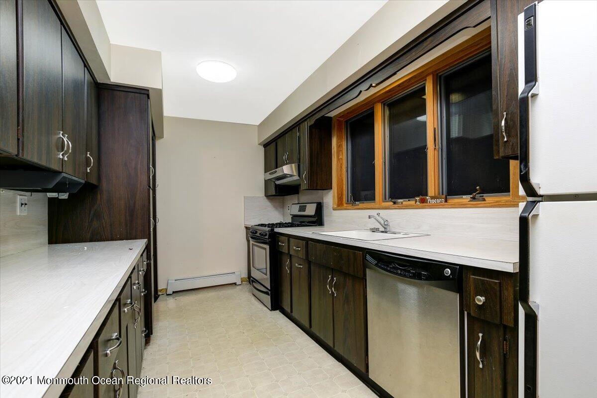 14 Hilltop Terrace Wayne, NJ 07470 - Photo 26 of 34 a kitchen with a sink and a refrigerator