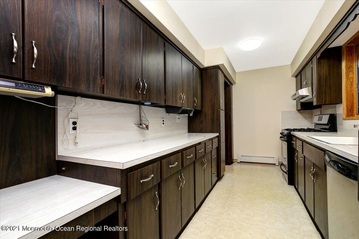 14 Hilltop Terrace Wayne, NJ 07470 - Photo 27 of 34 a kitchen with a sink appliances and cabinets