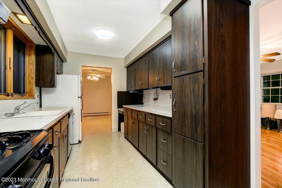 14 Hilltop Terrace Wayne, NJ 07470 - Photo 28 of 34 a kitchen with stainless steel appliances sink stove refrigerator and cabinets