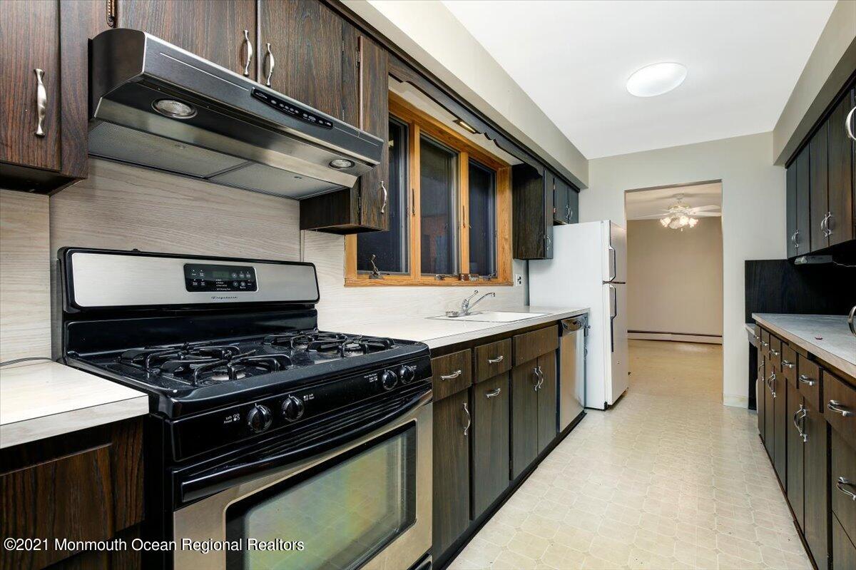 14 Hilltop Terrace Wayne, NJ 07470 - Photo 29 of 34 a kitchen with stainless steel appliances a stove and a microwave