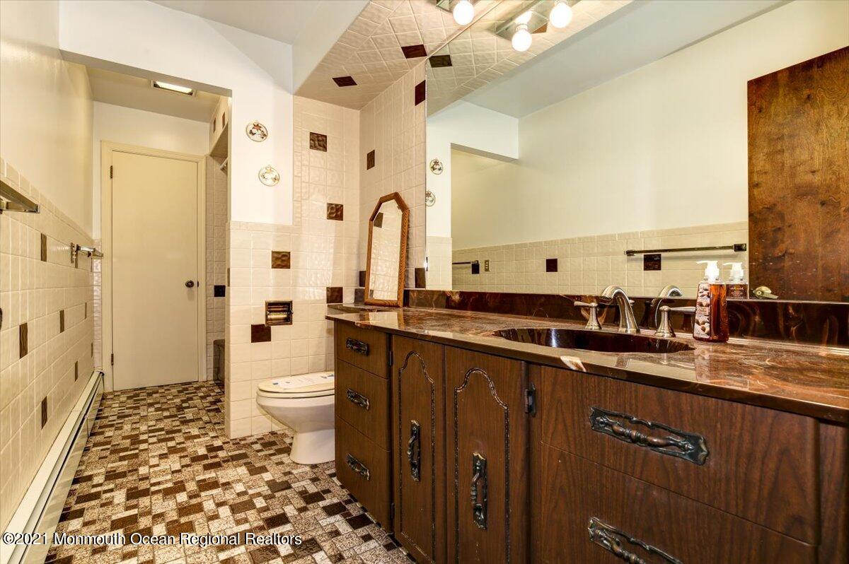 14 Hilltop Terrace Wayne, NJ 07470 - Photo 32 of 34 a bathroom with a double vanity sink toilet and shower