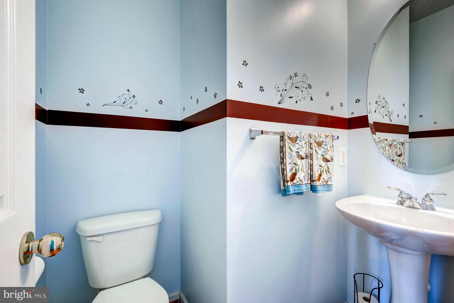 9714 Langley Road Baltimore, MD 21220 - Photo 13 of 27 a bathroom with a sink mirror and toilet