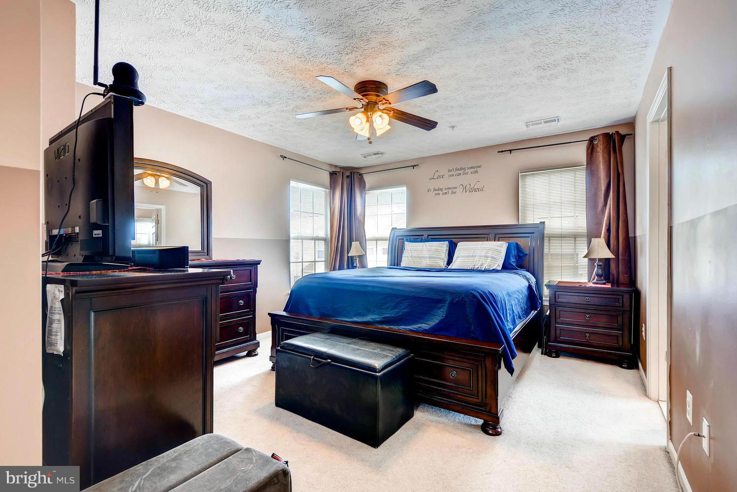 9714 Langley Road Baltimore, MD 21220 - Photo 14 of 27 a bedroom with a bed and a chandelier