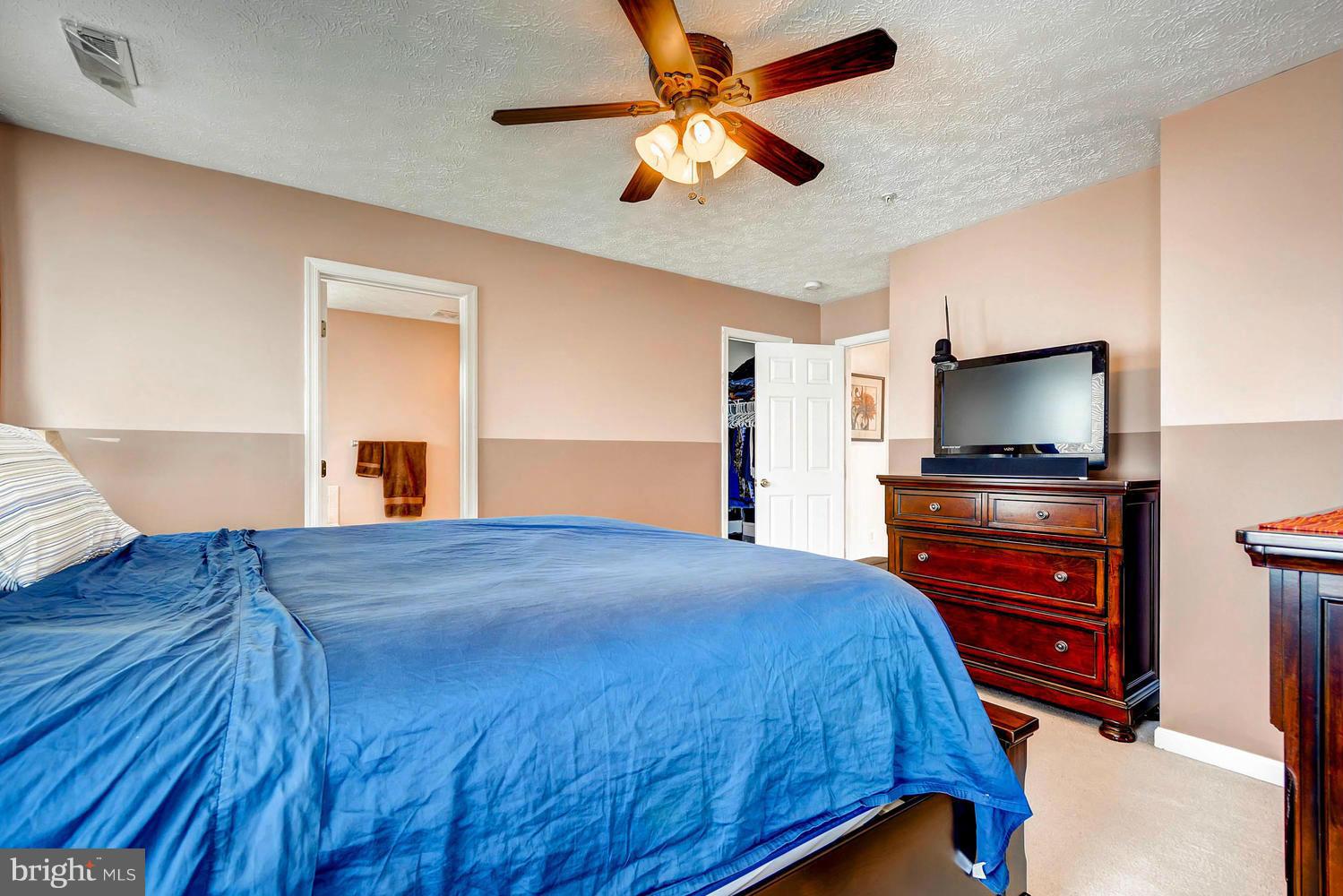 9714 Langley Road Baltimore, MD 21220 - Photo 15 of 27 a bedroom with a bed and a flat screen tv