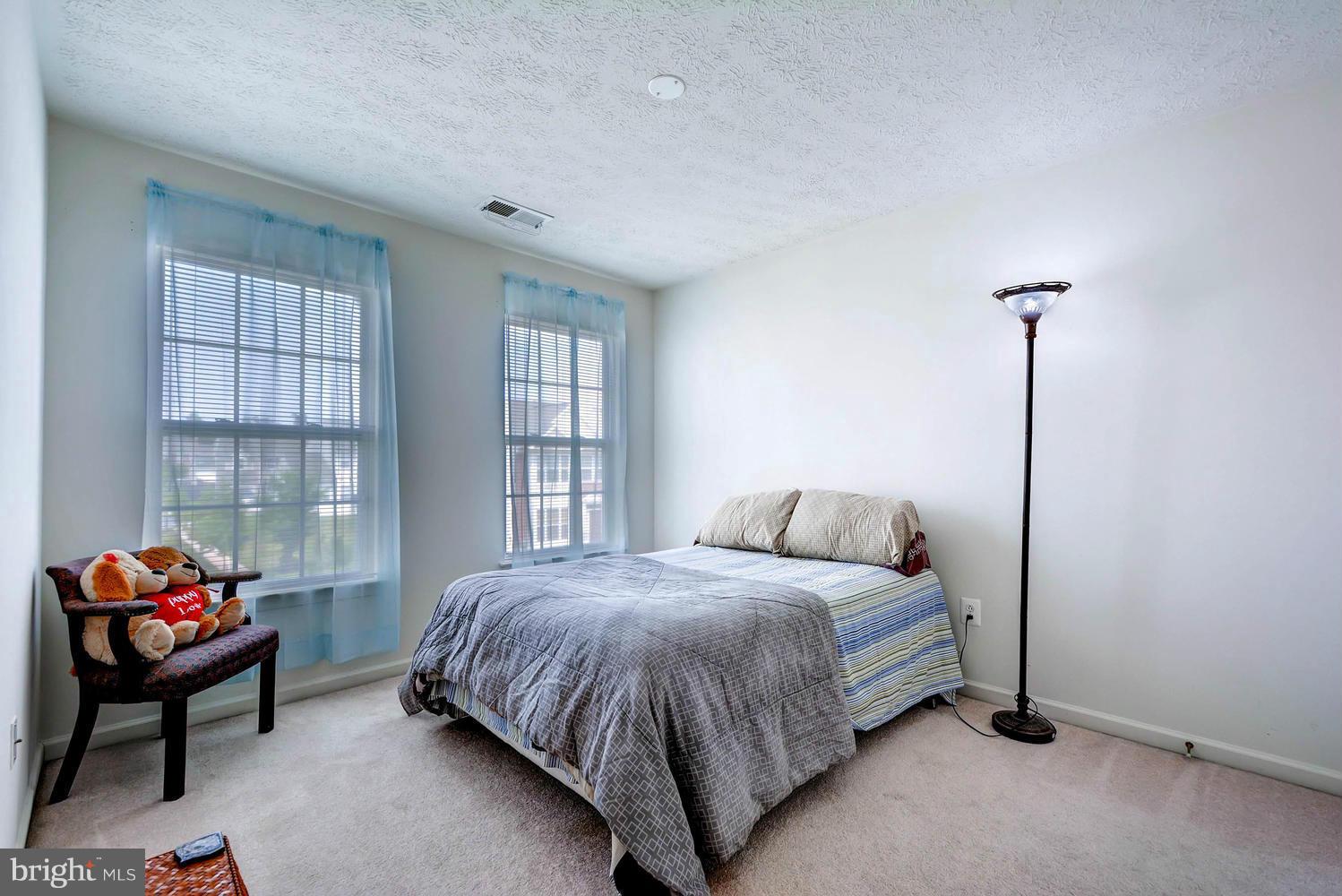 9714 Langley Road Baltimore, MD 21220 - Photo 18 of 27 a bedroom with a bed and window
