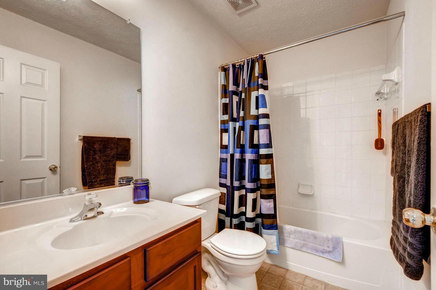 9714 Langley Road Baltimore, MD 21220 - Photo 20 of 27 a bathroom with a sink toilet and shower