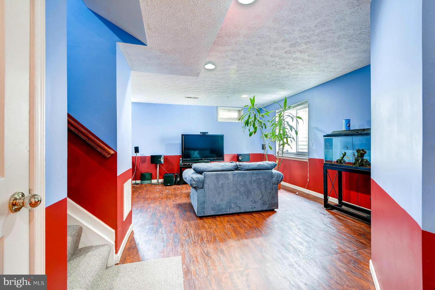 9714 Langley Road Baltimore, MD 21220 - Photo 22 of 27 a living room with furniture and a wooden floor