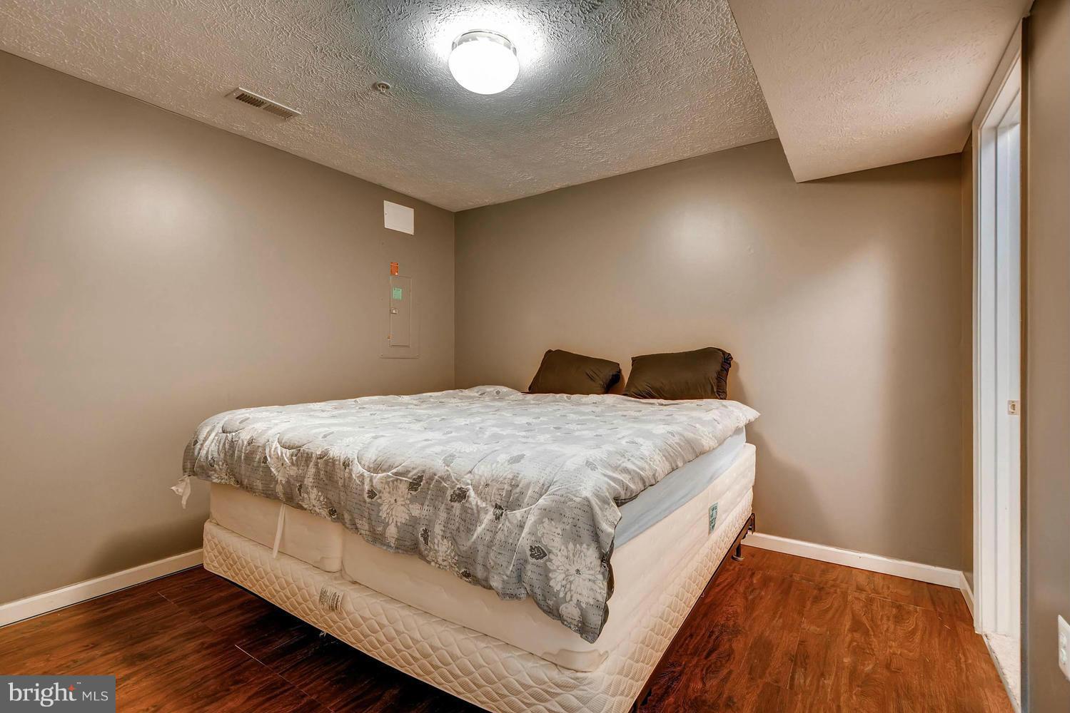 9714 Langley Road Baltimore, MD 21220 - Photo 24 of 27 a large bed sitting in a room next to a window