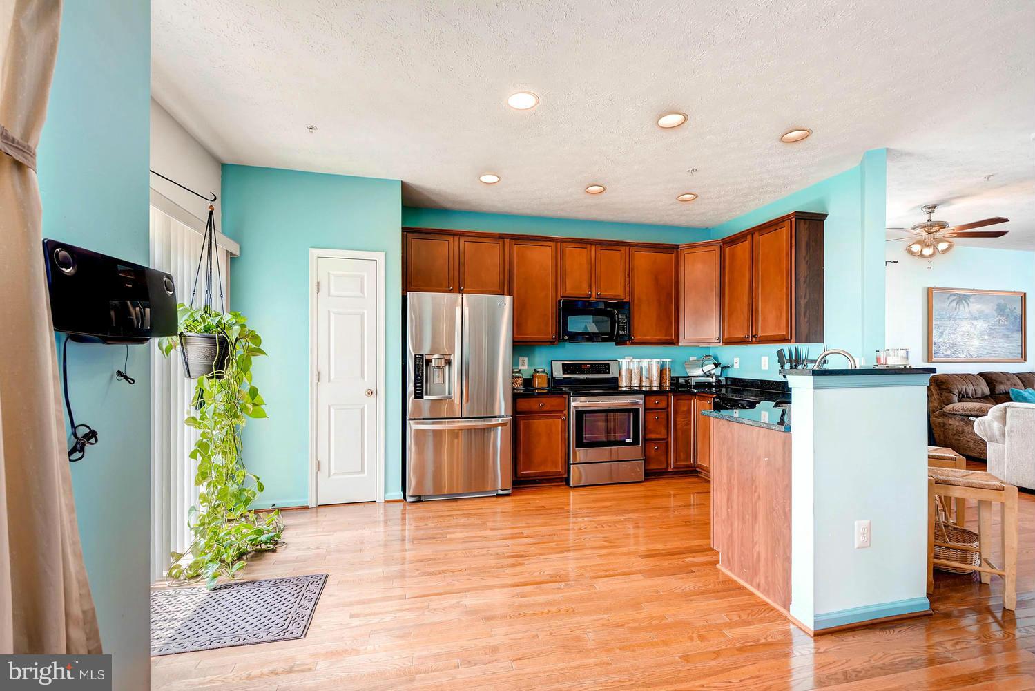 9714 Langley Road Baltimore, MD 21220 - Photo 8 of 27 a kitchen with stainless steel appliances kitchen island granite countertop a refrigerator and a stove