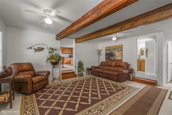 a bedroom with furniture and a rug