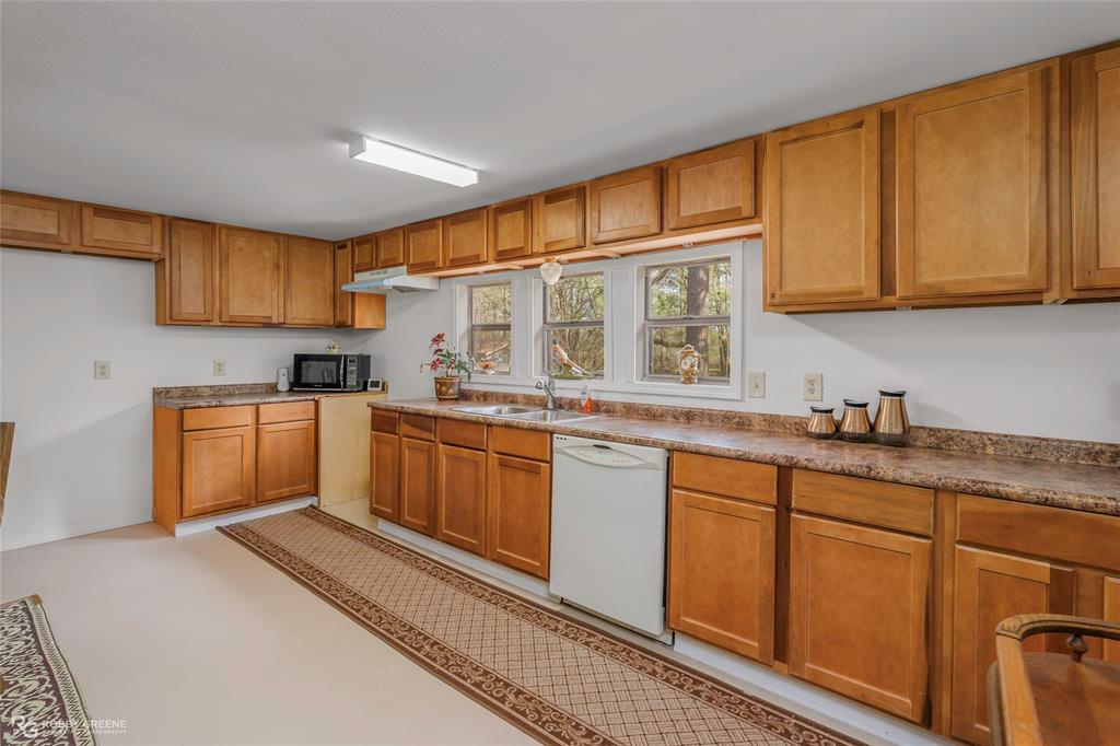 121 Willow Street Heflin, LA 71039 - Photo 17 of 39 a kitchen with granite countertop a sink cabinets stainless steel appliances and a counter top space