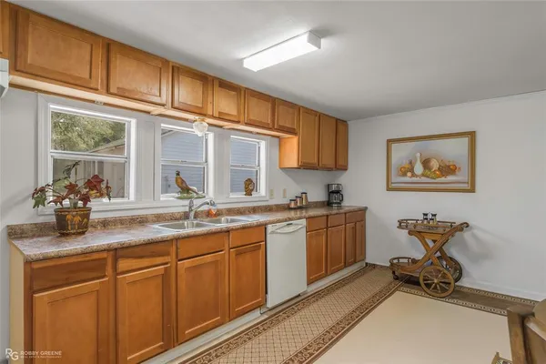 a kitchen with sink cabinets and window
