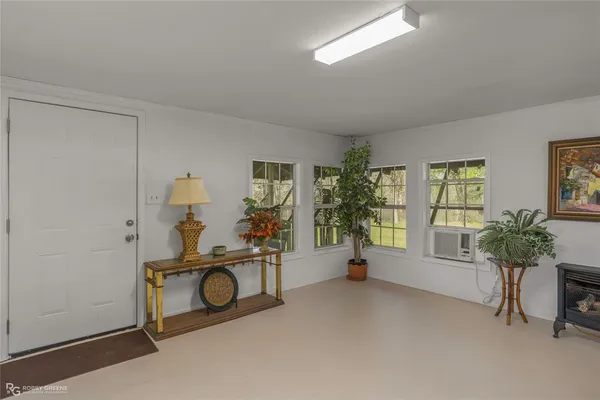a view of a livingroom with furniture and a window