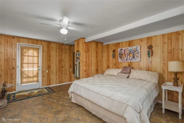 a bedroom with a large bed and a chandelier