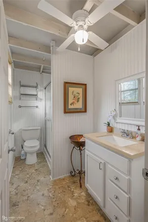 a view of a bathroom with a sink a toilet and a mirror