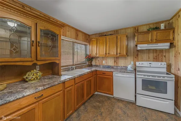 a kitchen that has a sink and a stove