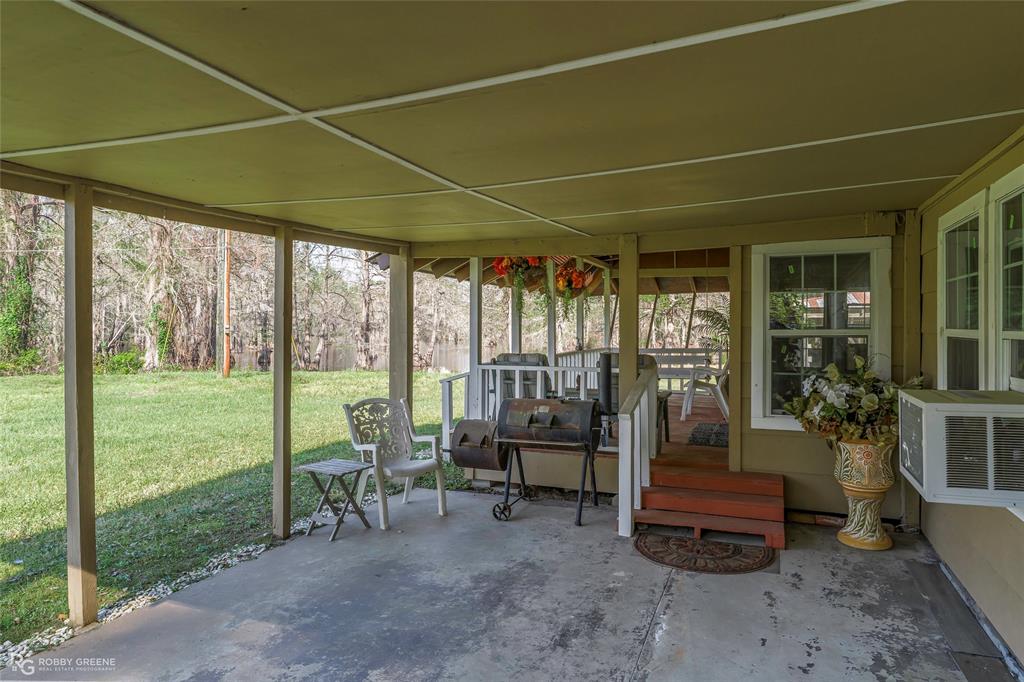 121 Willow Street Heflin, LA 71039 - Photo 9 of 39 a living room with furniture and floor to ceiling windows