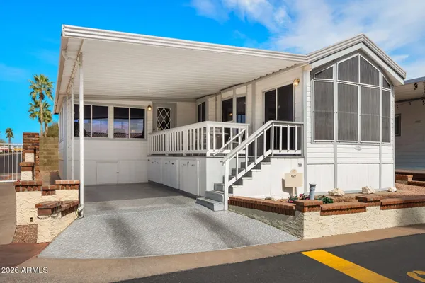 a view of a house with backyard and porch