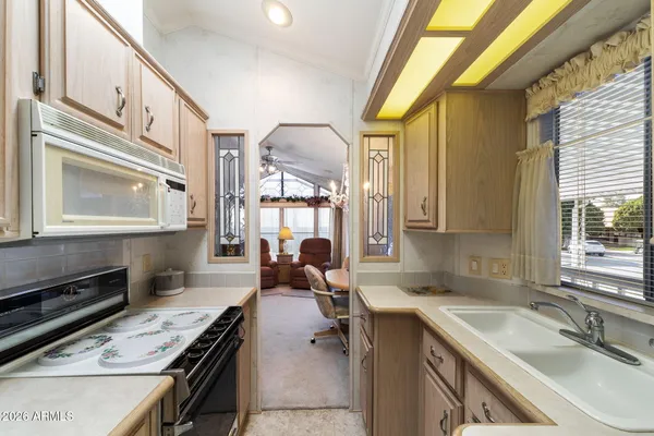 a kitchen with a sink a stove and cabinets