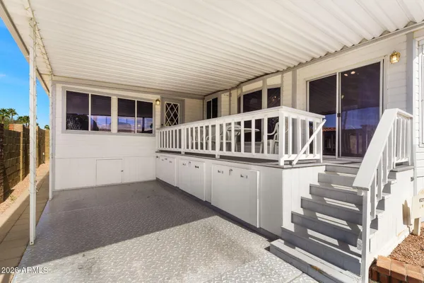 a view of house with deck and balcony