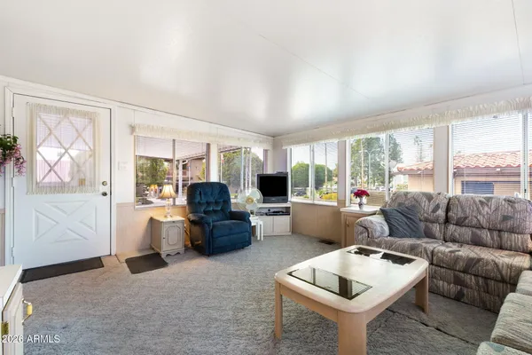 a living room with furniture and a large window