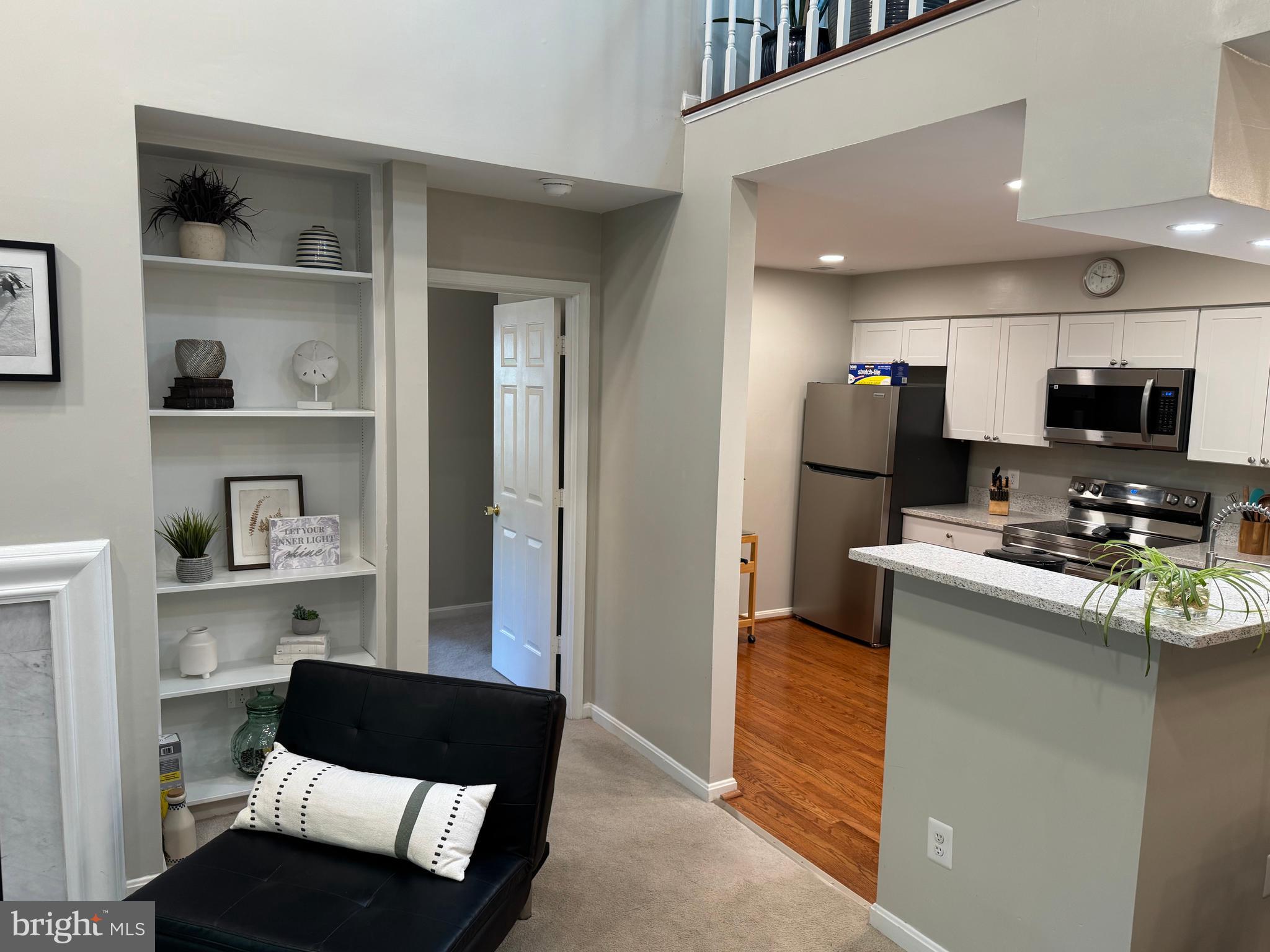11709 Karbon Hill Court, Unit I Reston, VA 20191 - Photo 13 of 38 a living room with stainless steel appliances furniture a rug and a kitchen view