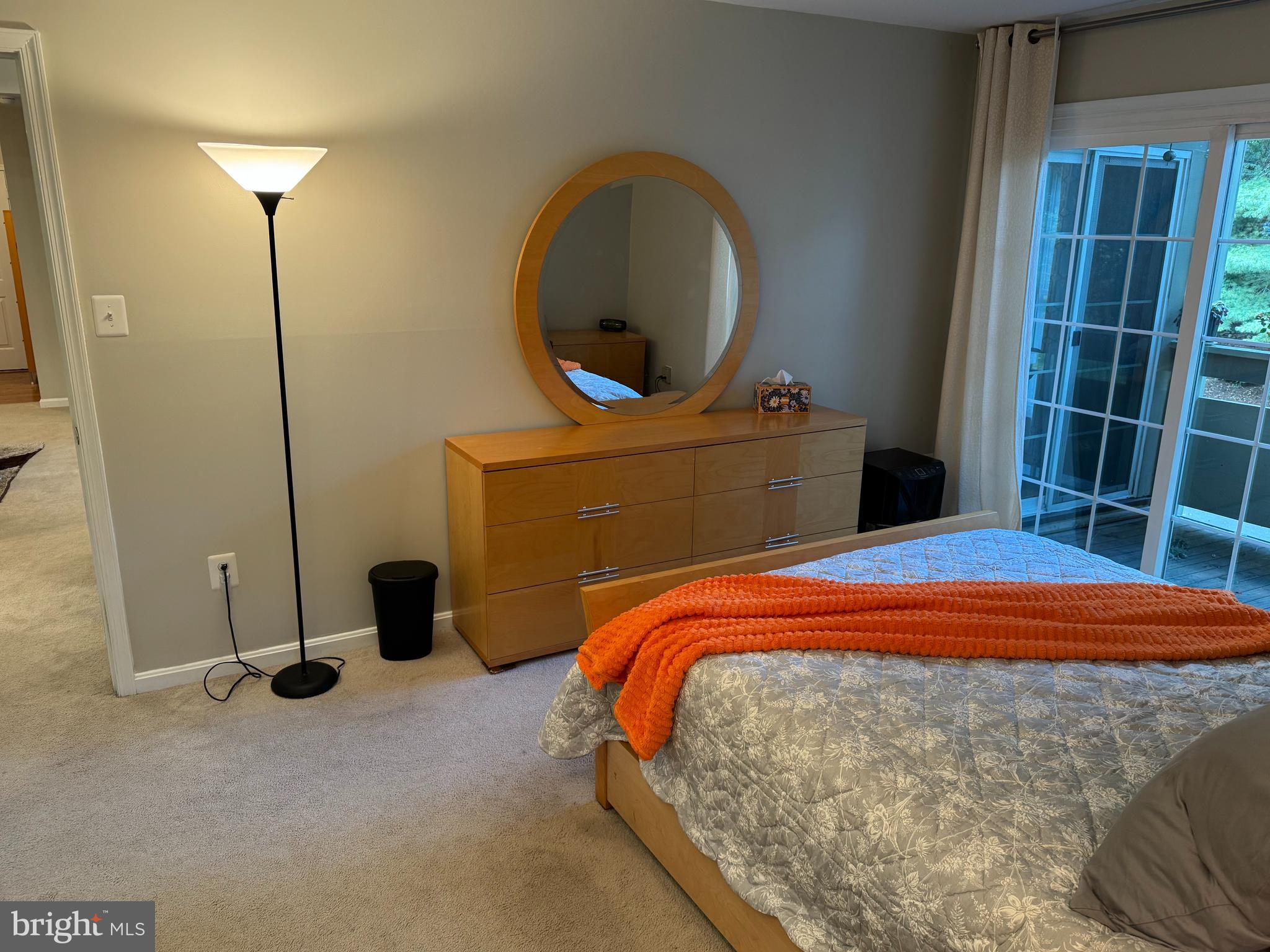 11709 Karbon Hill Court, Unit I Reston, VA 20191 - Photo 27 of 38 a bedroom with a bed and a mirror