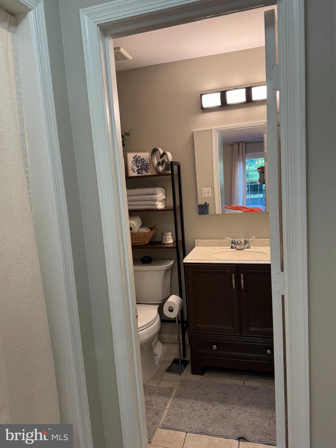 11709 Karbon Hill Court, Unit I Reston, VA 20191 - Photo 28 of 38 a bathroom with a sink and a mirror