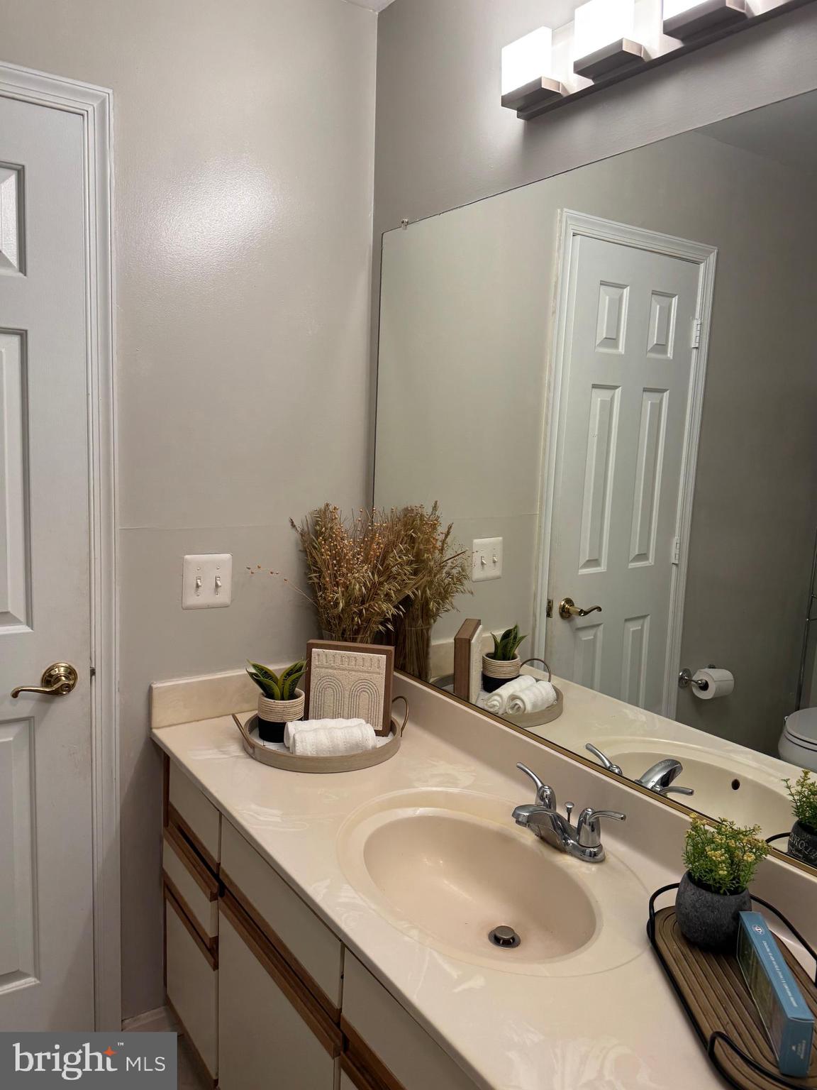 11709 Karbon Hill Court, Unit I Reston, VA 20191 - Photo 30 of 38 a bathroom with a sink and a mirror