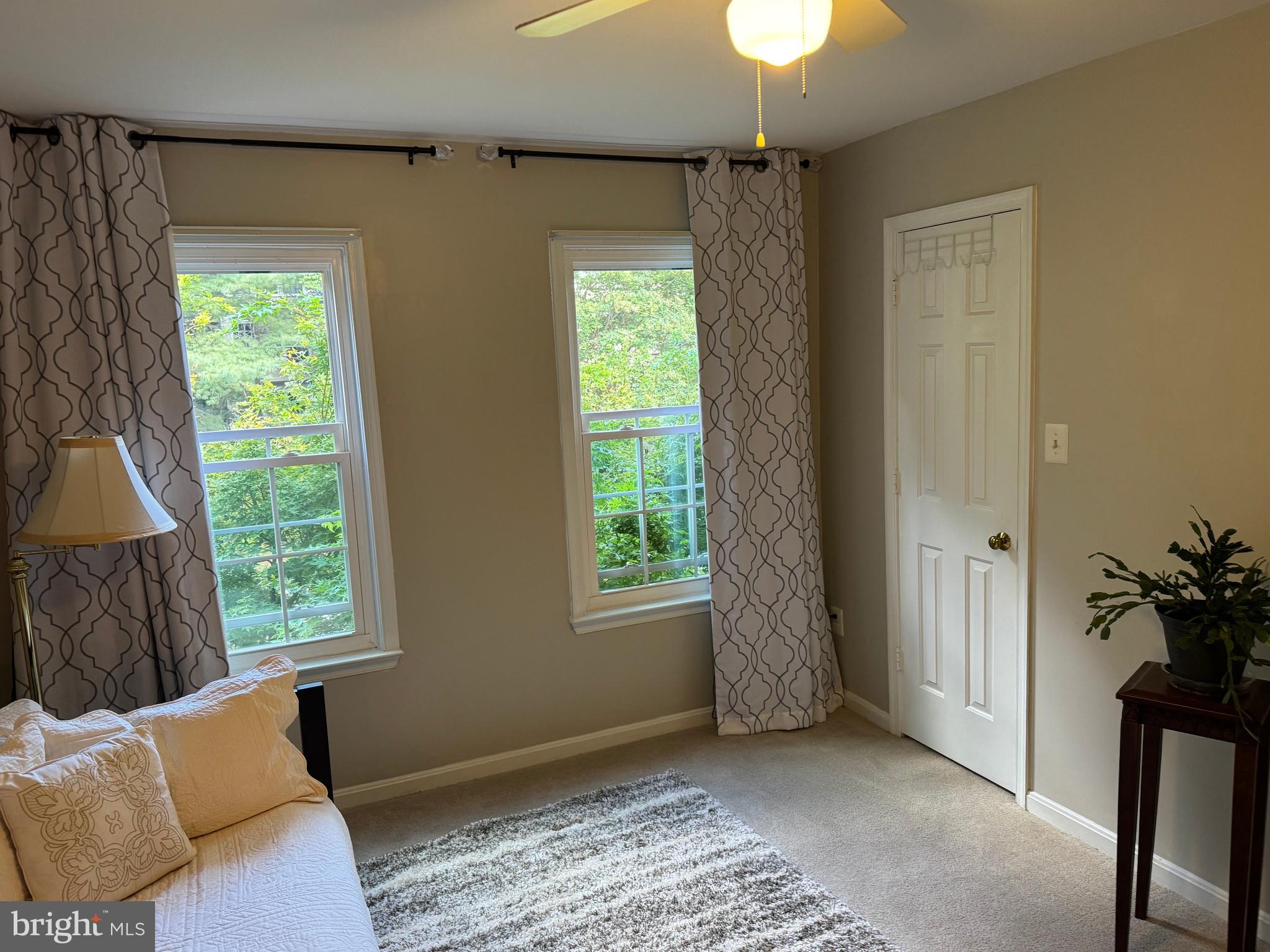 11709 Karbon Hill Court, Unit I Reston, VA 20191 - Photo 35 of 38 a bedroom with windows and a chandelier