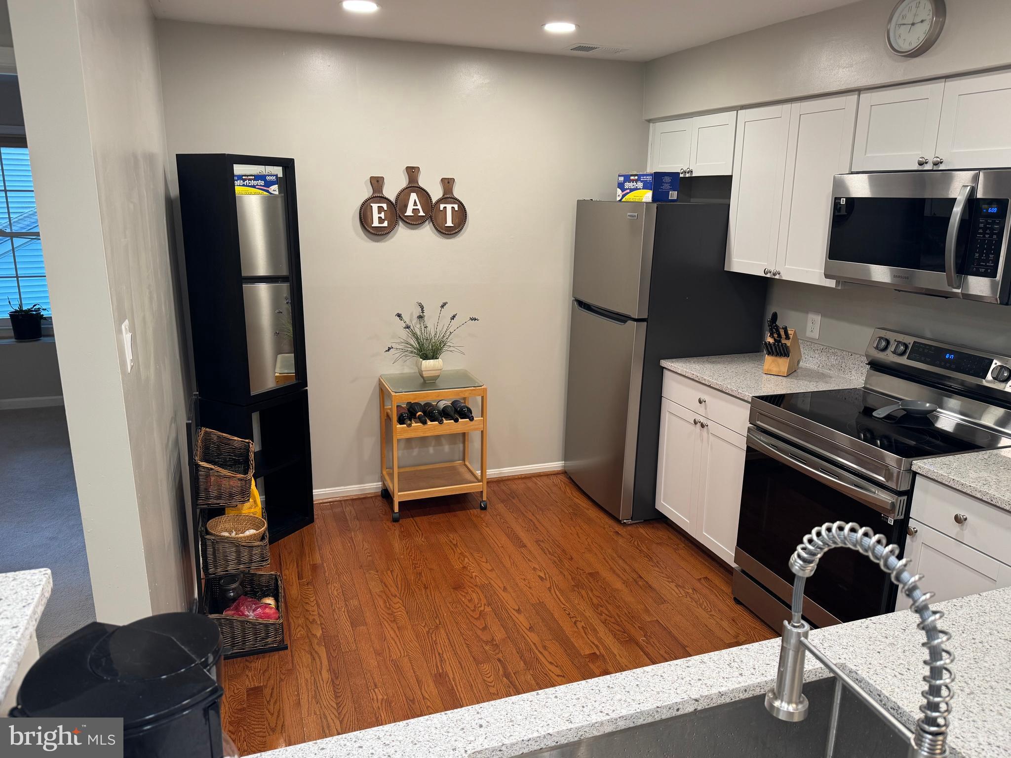 11709 Karbon Hill Court, Unit I Reston, VA 20191 - Photo 4 of 38 a kitchen with stainless steel appliances a refrigerator and a stove top oven
