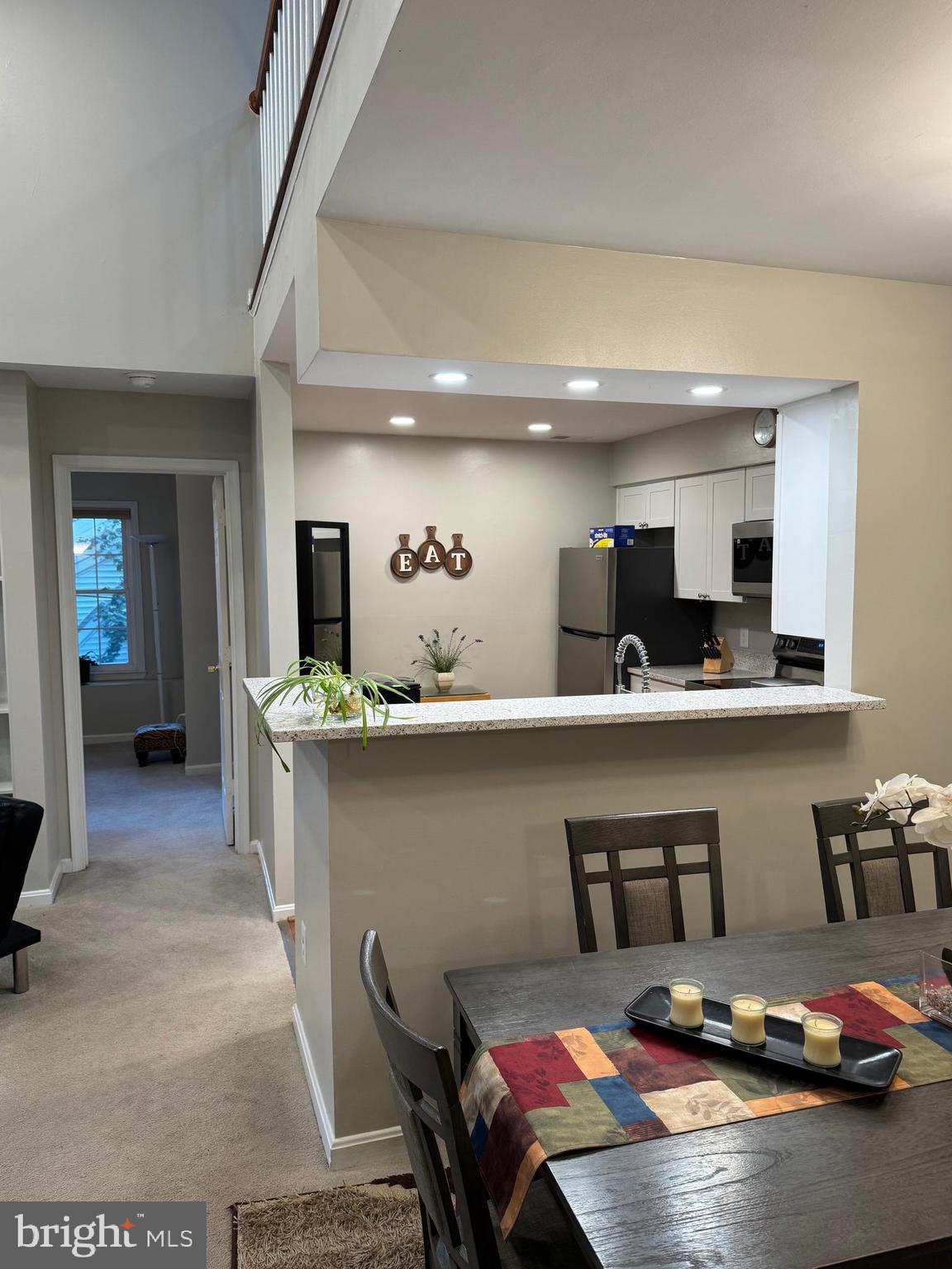 11709 Karbon Hill Court, Unit I Reston, VA 20191 - Photo 5 of 38 a kitchen with a table chairs in it and wooden floors
