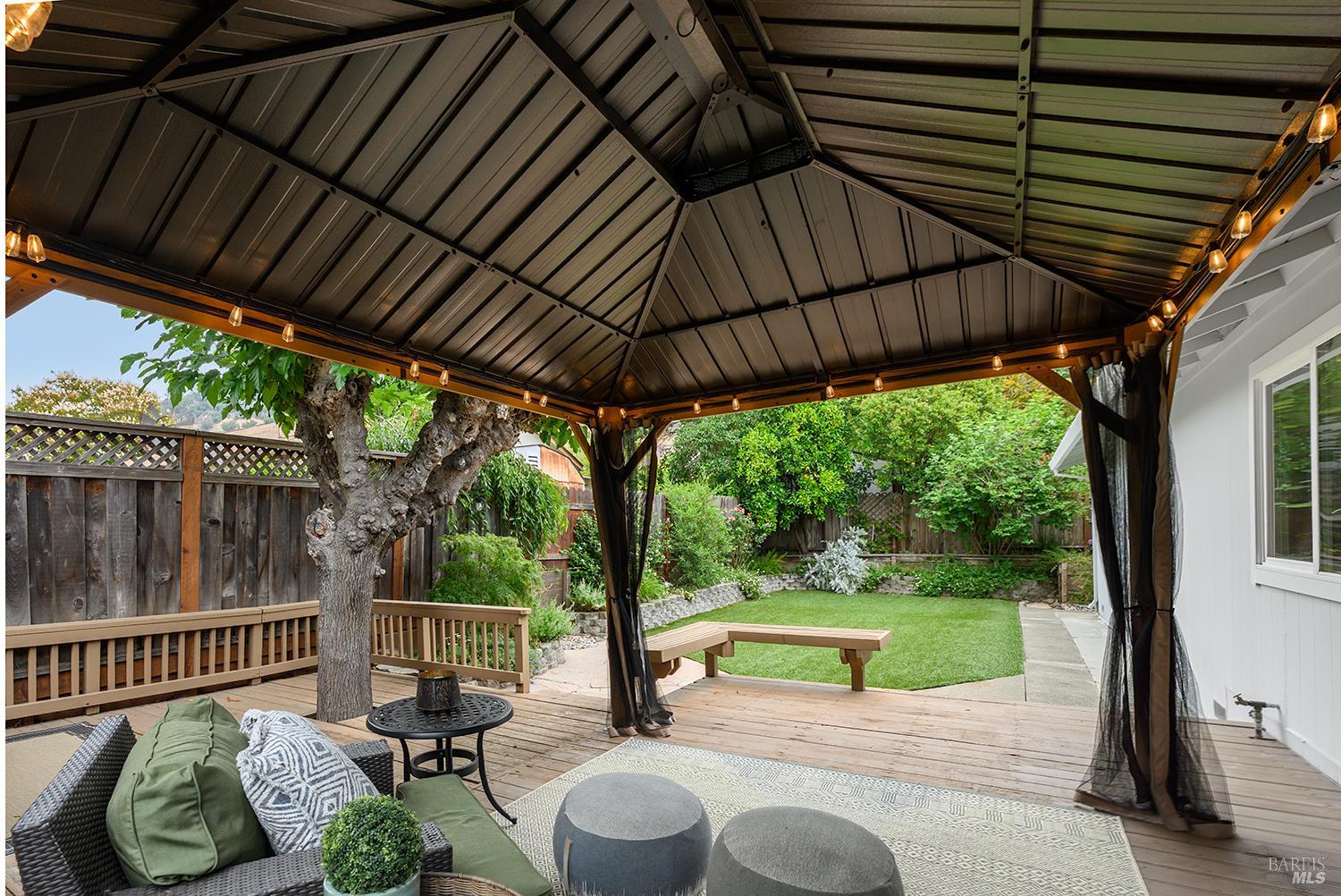 5313 Yerba Buena Road Santa Rosa, CA 95409 - Photo 21 of 34 Designed for easy enjoyment, the backyard features low-maintenance turf, mature landscaping, and multiple spaces to gather with family and friends.