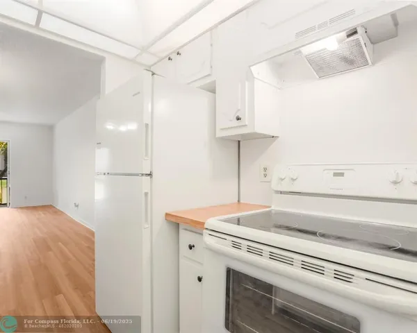 a kitchen with a stove and a refrigerator
