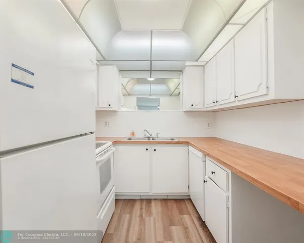 a kitchen with cabinets and white appliances