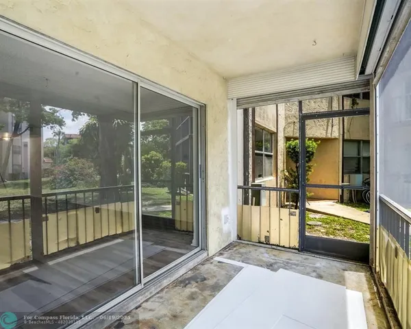 a view of a glass door and a living room