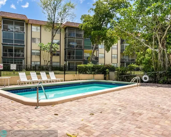 a swimming pool with outdoor seating and yard